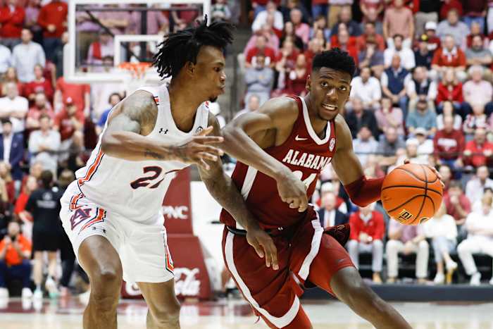 Alabama Crimson Tide forward Brandon Miller (24) dribbles around Auburn Tigers guard Allen Flanigan (22) during the second half of an NCAA basketball game at Coleman Coliseum.